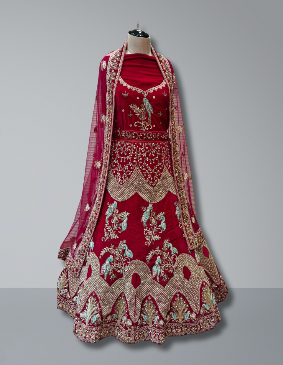 Luxury Velvet Bridal Lehenga in Crimson Red with Peacock Motifs and Embroidered Detailing