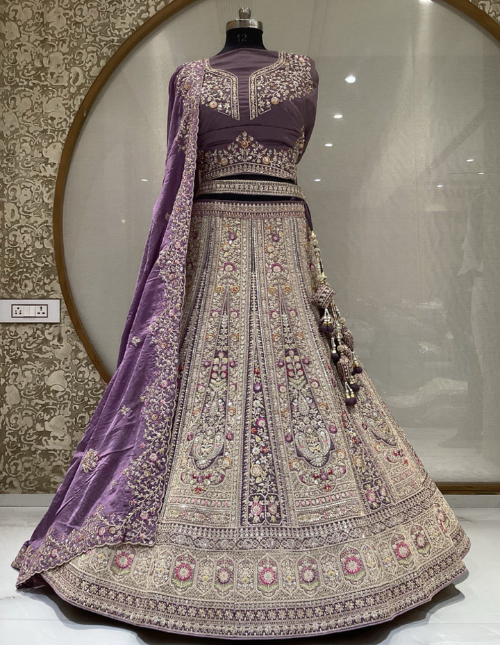 Royal purple bridal lehenga with intricate gold embroidery and sequin work