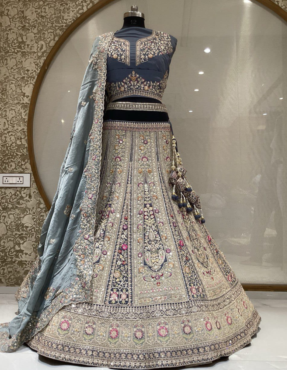 Vibrant cyan bridal lehenga with shimmering golden embellishments and a matching dupatta